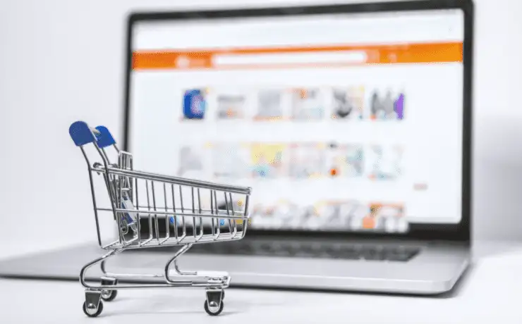 Optimise Online Marketing with the Best Shopify Plugins 7 Shopping cart trolley in front of laptop for best shopify plugins