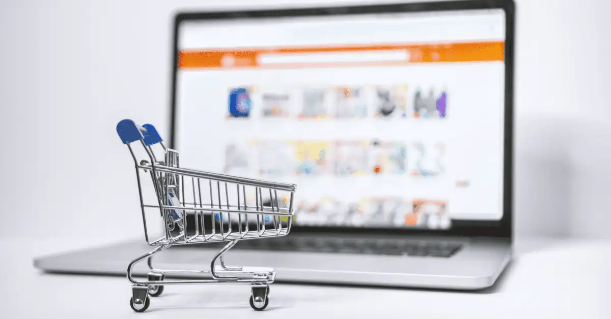 Optimise Online Marketing with the Best Shopify Plugins 2 Shopping cart trolley in front of laptop for best shopify plugins
