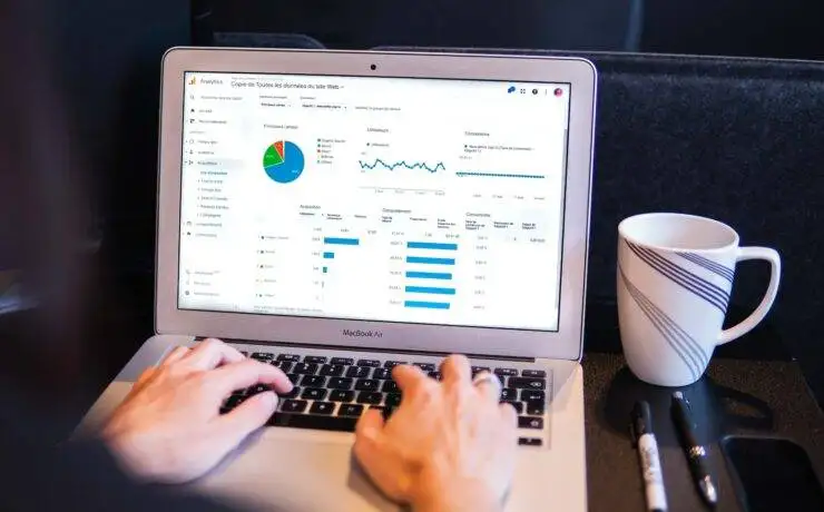 Revolutionising Digital Marketing: The Future of Data Analytics 4 Woman working on a laptop with data analytics for digital marketing.