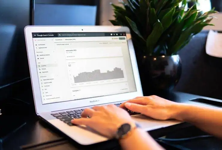 Hands on a laptop with an seo or analytics page open