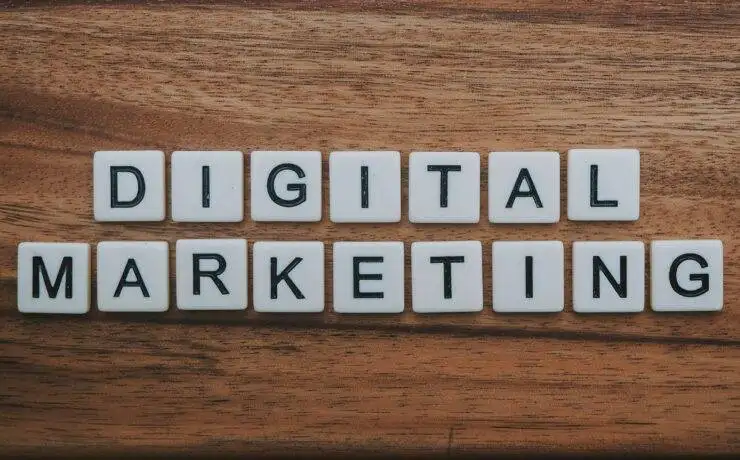 Scrabble tiles on a wooden surface spelling out digital marketing