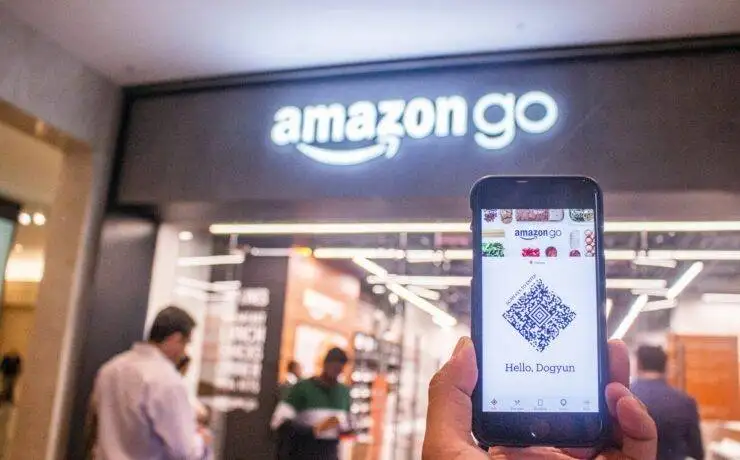 How to Optimise Your E-commerce Store for Mobile Shoppers 3 The image shows a close-up of a person holding a black Samsung Android smartphone. The phone is held in one hand, with the screen facing the viewer, displaying a well-organized home screen. The background is blurred, allowing the focus to remain on the smartphone and the hand holding it. The lighting is soft and natural, highlighting the sleek design of the phone and the user's grip. The overall composition conveys a modern and connected lifestyle, emphasizing the role of smartphones in everyday life