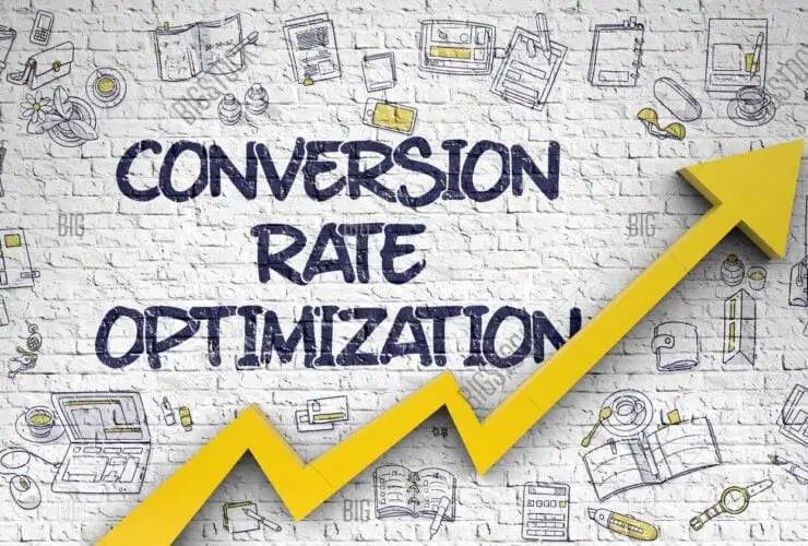 The image shows a whiteboard or a poster with the words "Conversion Rate Optimisation" written in bold, black letters. The person is only partially visible, with the focus on their hands holding the board. The background is plain and light-coloured, ensuring that the text on the whiteboard stands out clearly. The message is straightforward and prompts the viewer to consider their approach or plan of action, making it an effective visual for discussions or presentations about business strategy, planning, or decision-making.