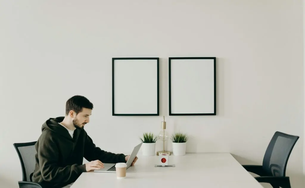 a man sitting at a table with a laptop