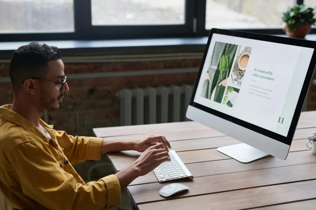a man sitting at a desk using a computer looking up what an SEO company is 
