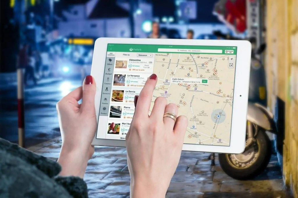 a person using a tablet looking at local seo