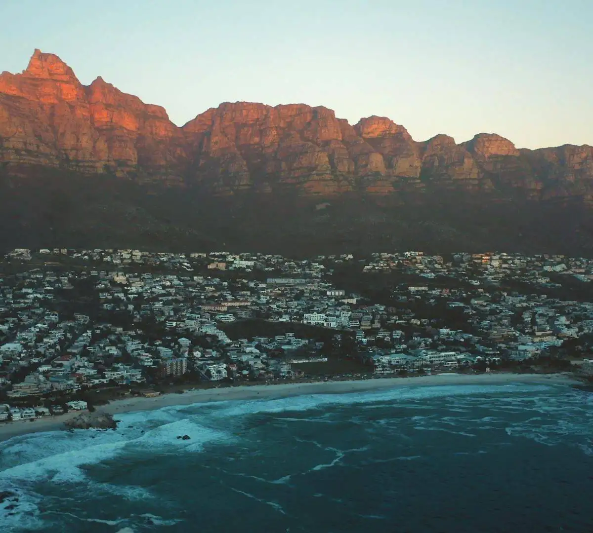 How To Market Your Business Online In South Africa In 2024 2 a city on a beach with mountains in the background in South Africa