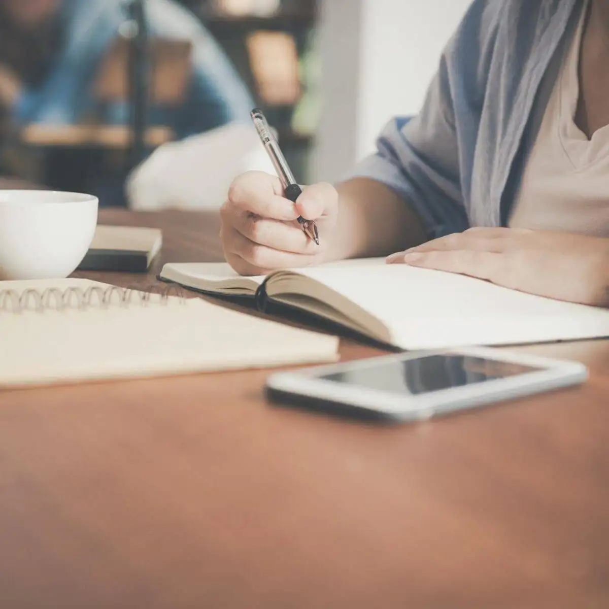 The Ultimate Guide to Choosing the Right SEO Optimization Company for Your Business 2 a person writing in a notebook about seo optimization companies