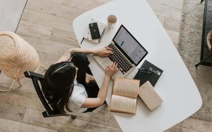 Finding Quality SEO Services Near Me: A Comprehensive Guide for Local Businesses in 2024 10 a woman sitting at a table using a laptop looking for SEO services near me