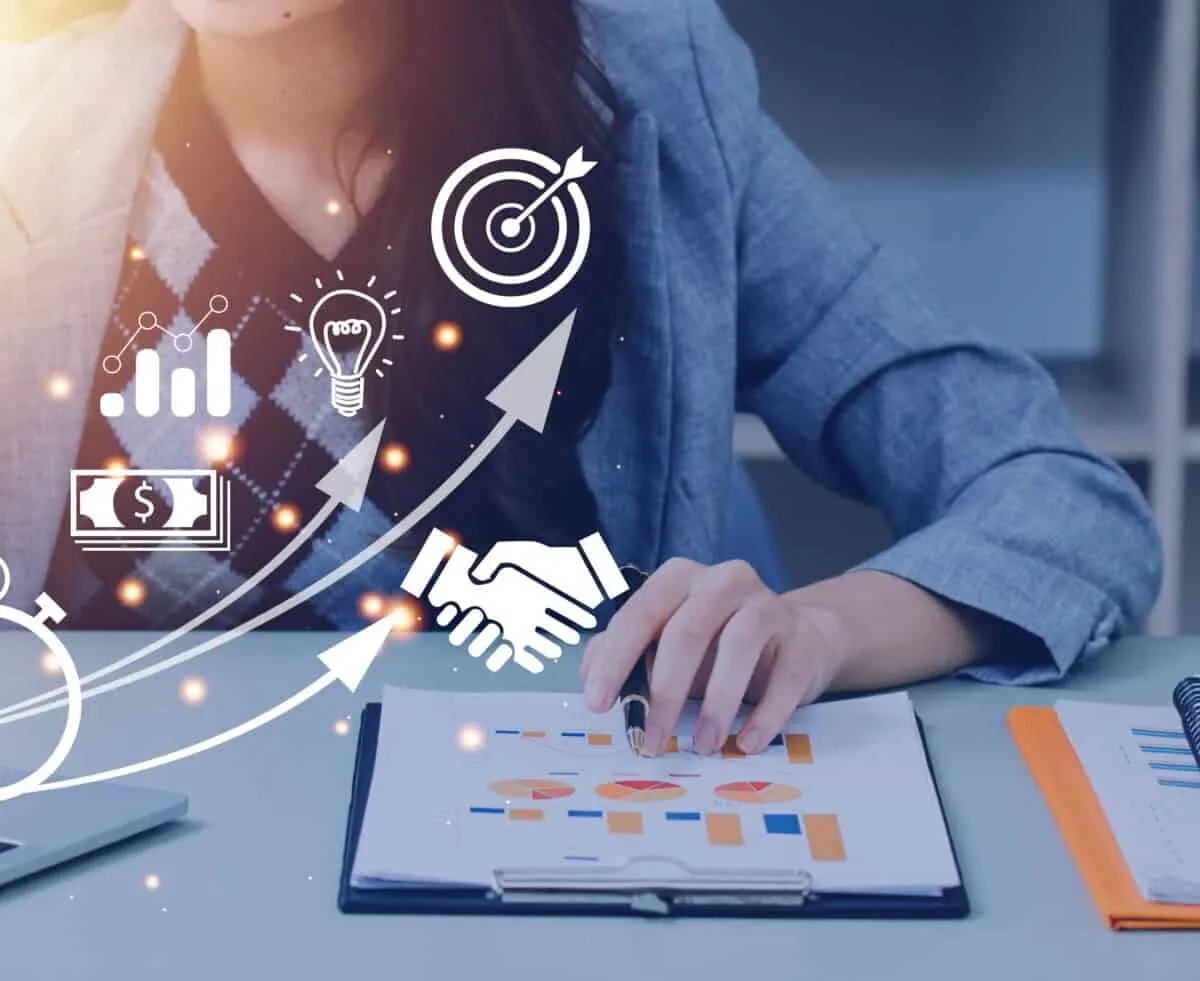 A female digital marketer analysing website performance with traffic, intent, and conversion growth icons on a laptop