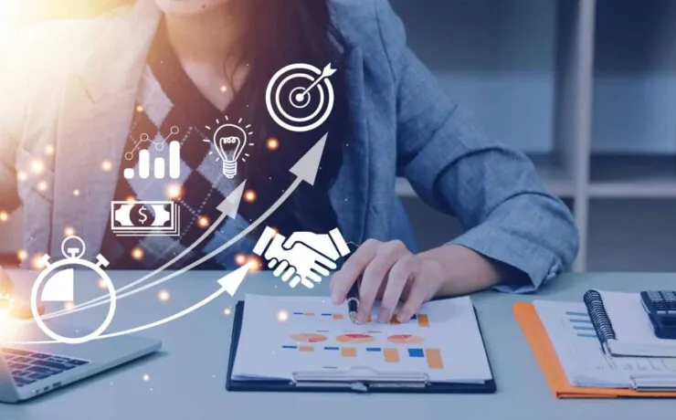 A female digital marketer analysing website performance with traffic, intent, and conversion growth icons on a laptop