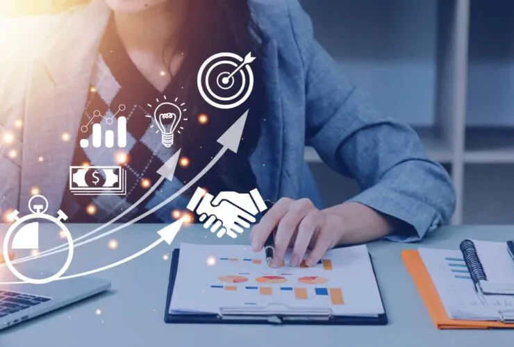 A female digital marketer analysing website performance with traffic, intent, and conversion growth icons on a laptop