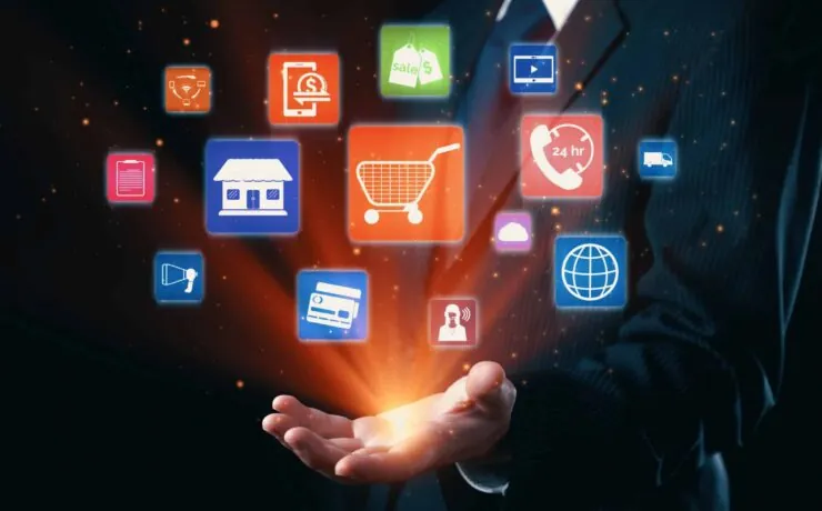 A business professional with icons representing omnichannel marketing, including online store, shopping cart, customer service, and more, floating above their hand.