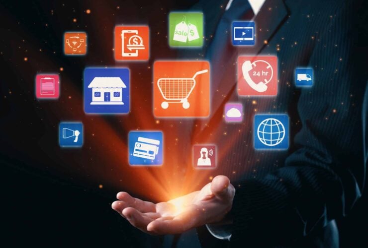 A business professional with icons representing omnichannel marketing, including online store, shopping cart, customer service, and more, floating above their hand.